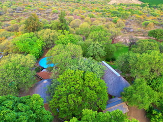Ngoma Bush Lodge thatched bungalows overlooking the bushveld at sunset in Hoedspruit near Kruger National Park
